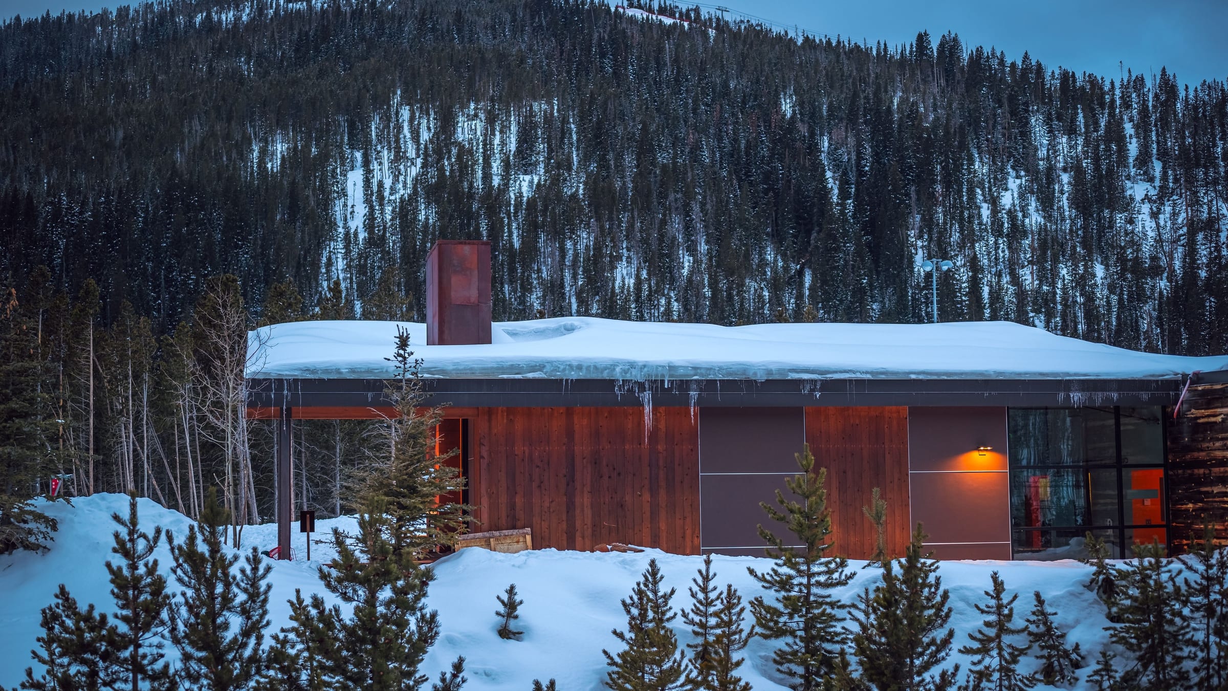 A mountain residence under snow, the landscape and the architecture holding equal weight.
