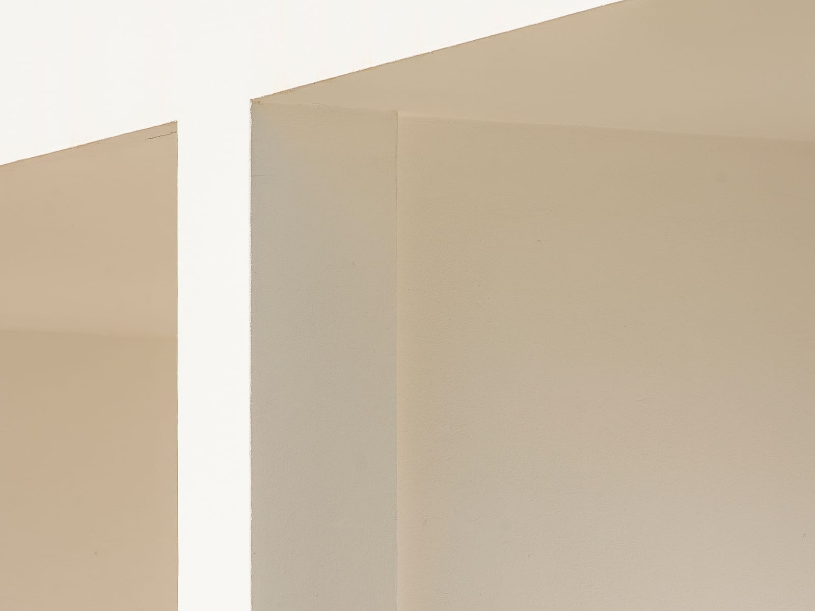 The same kind of surface finished, wall planes meeting flat and even in soft daylight.