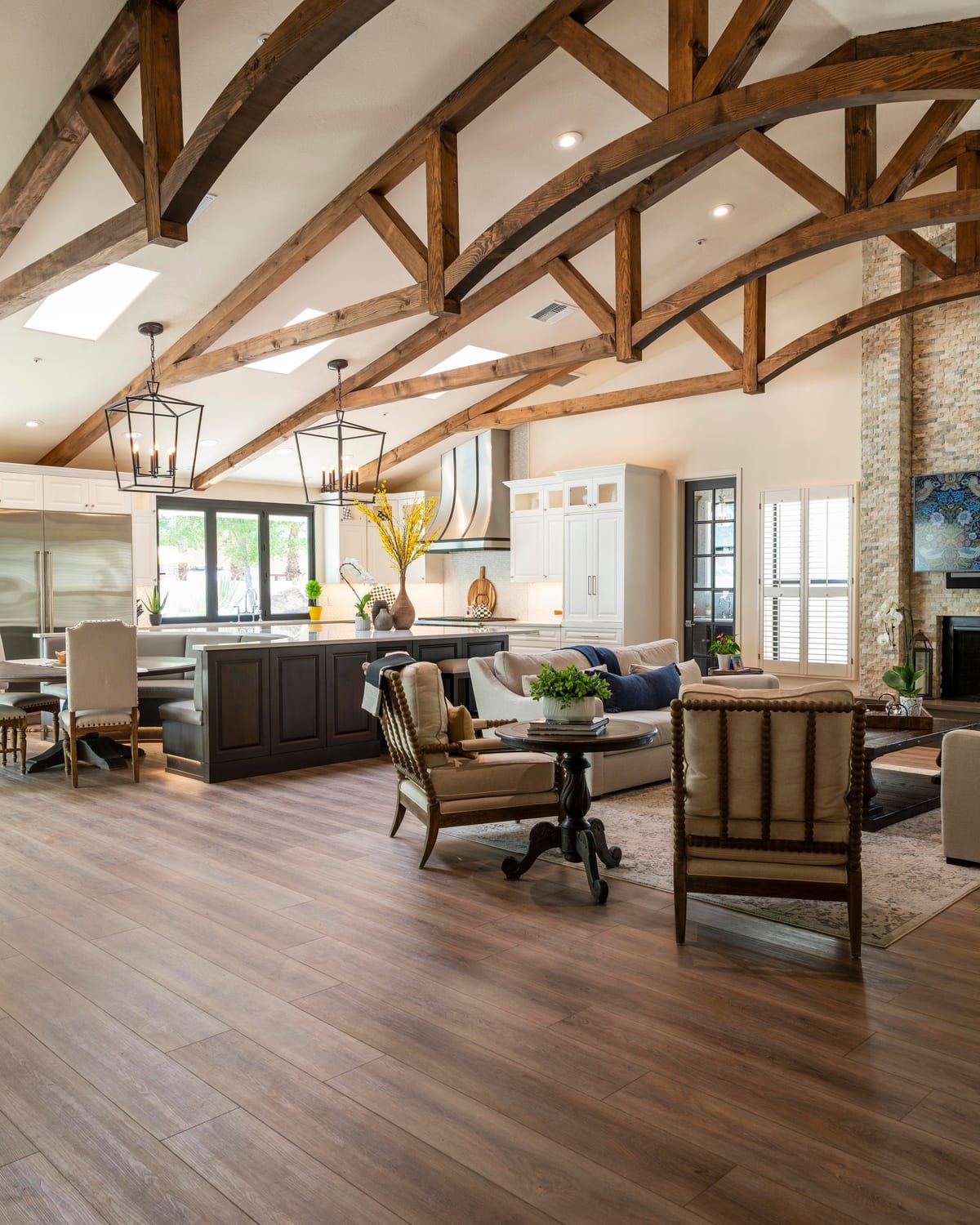 A vaulted great room in warm daylight, where painted walls, ceiling, and custom trim meet in clean, unbroken lines.
