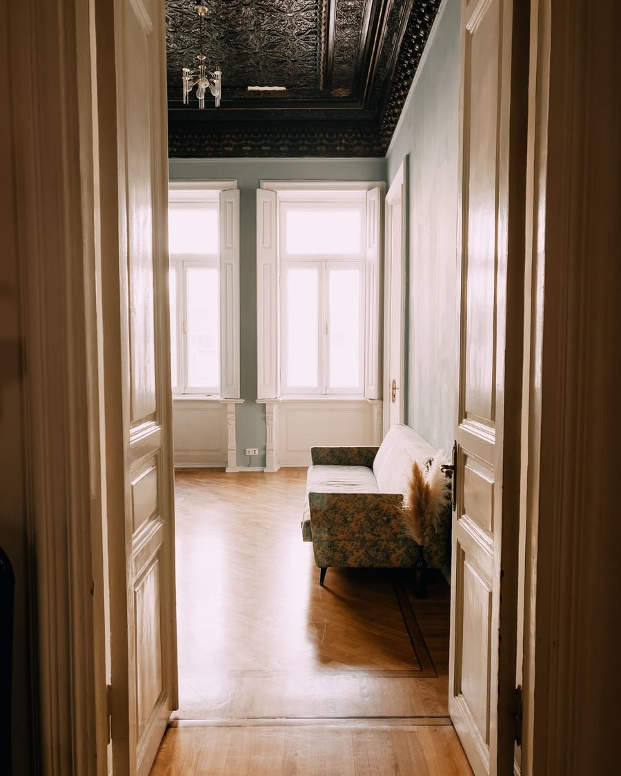Interior door casings layered down a hallway, every profile finished smooth in daylight.