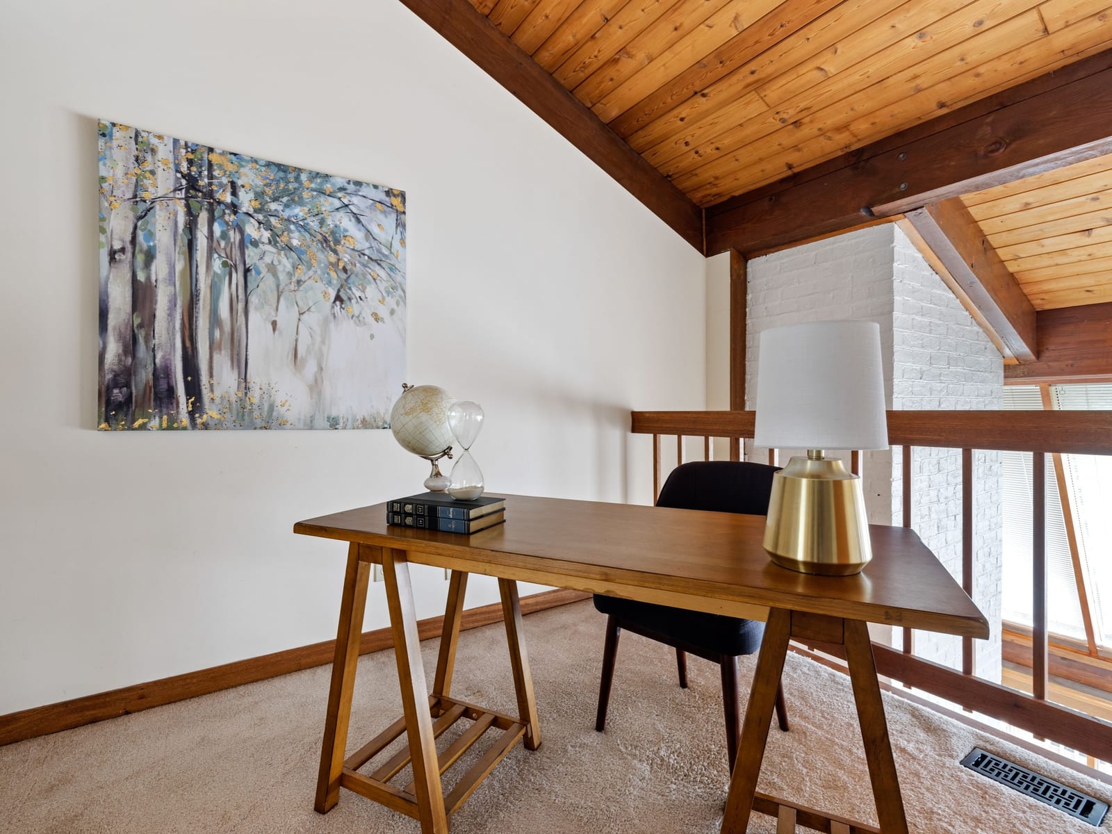 A vaulted room where painted walls meet a natural timber ceiling, each material left to read as itself.