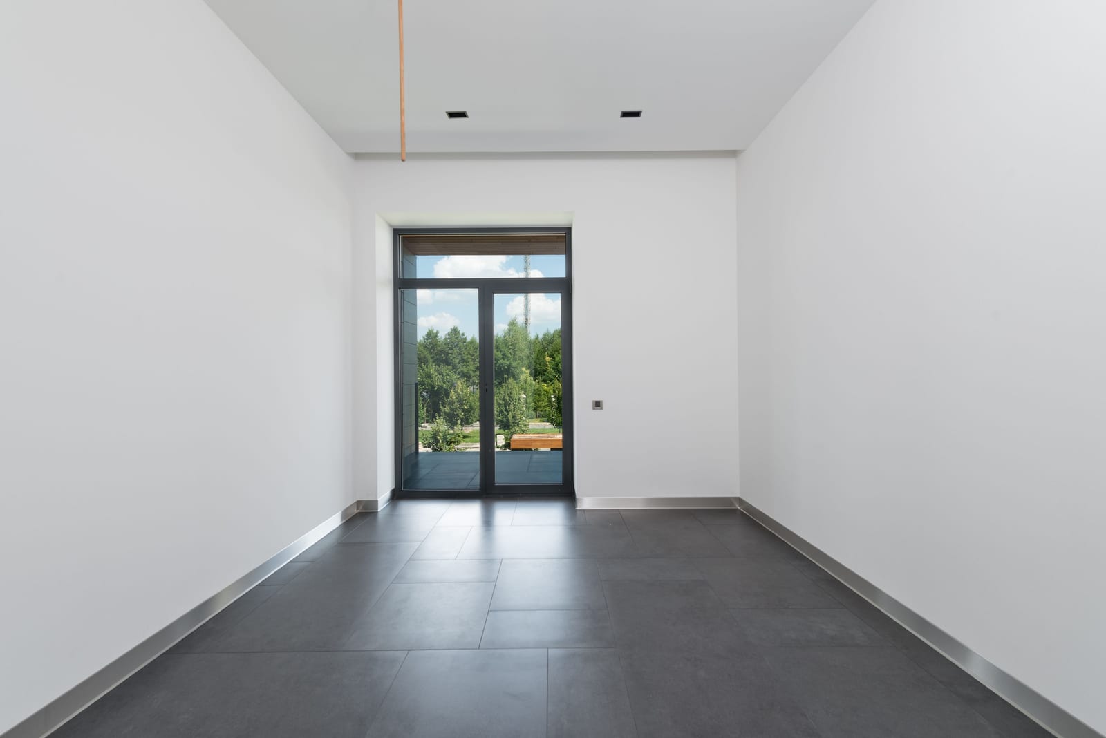 A finished room in raking light, floors protected and surfaces left flat, even, and in order.