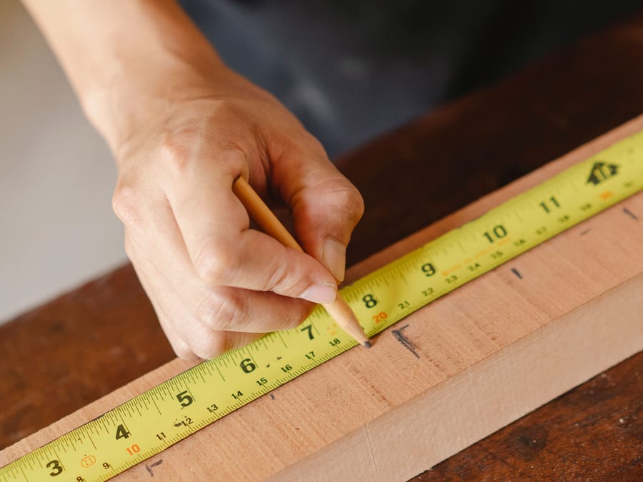 A length of trim being measured and marked before it is cut and fitted.