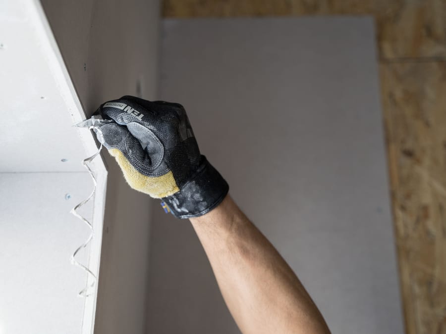 A filled and sanded repair feathered into a wall, waiting to be primed.