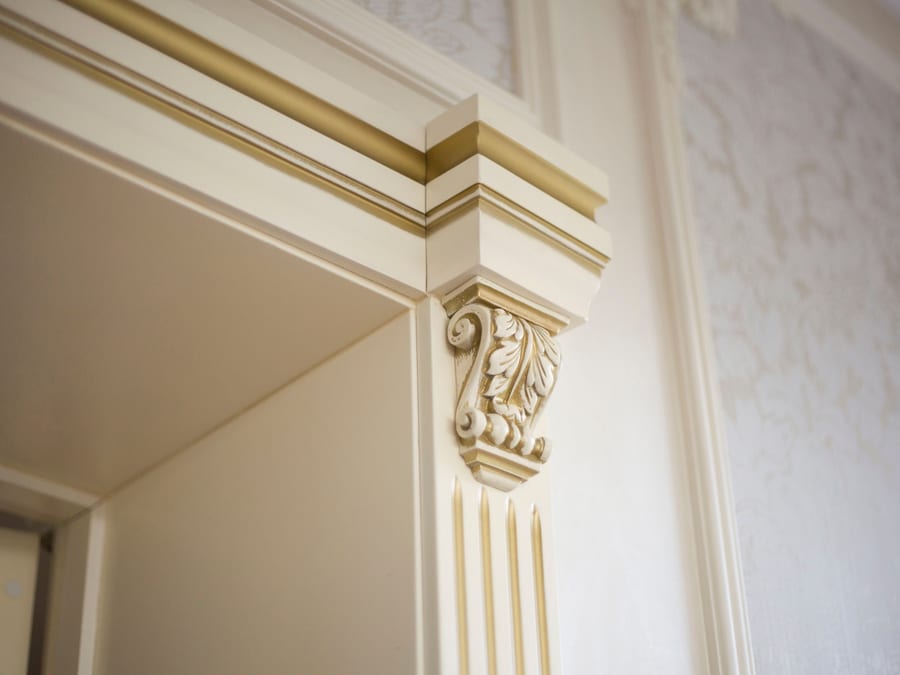 A painted trim profile meeting a wall in one clean, continuous line.
