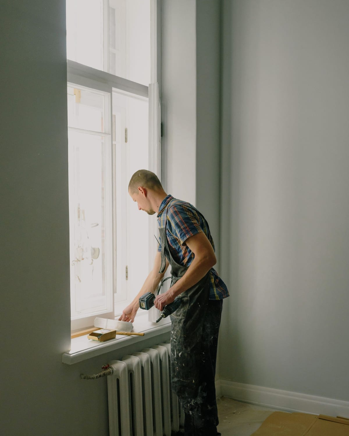 A craftsman photographed at work in natural light, tools at hand.